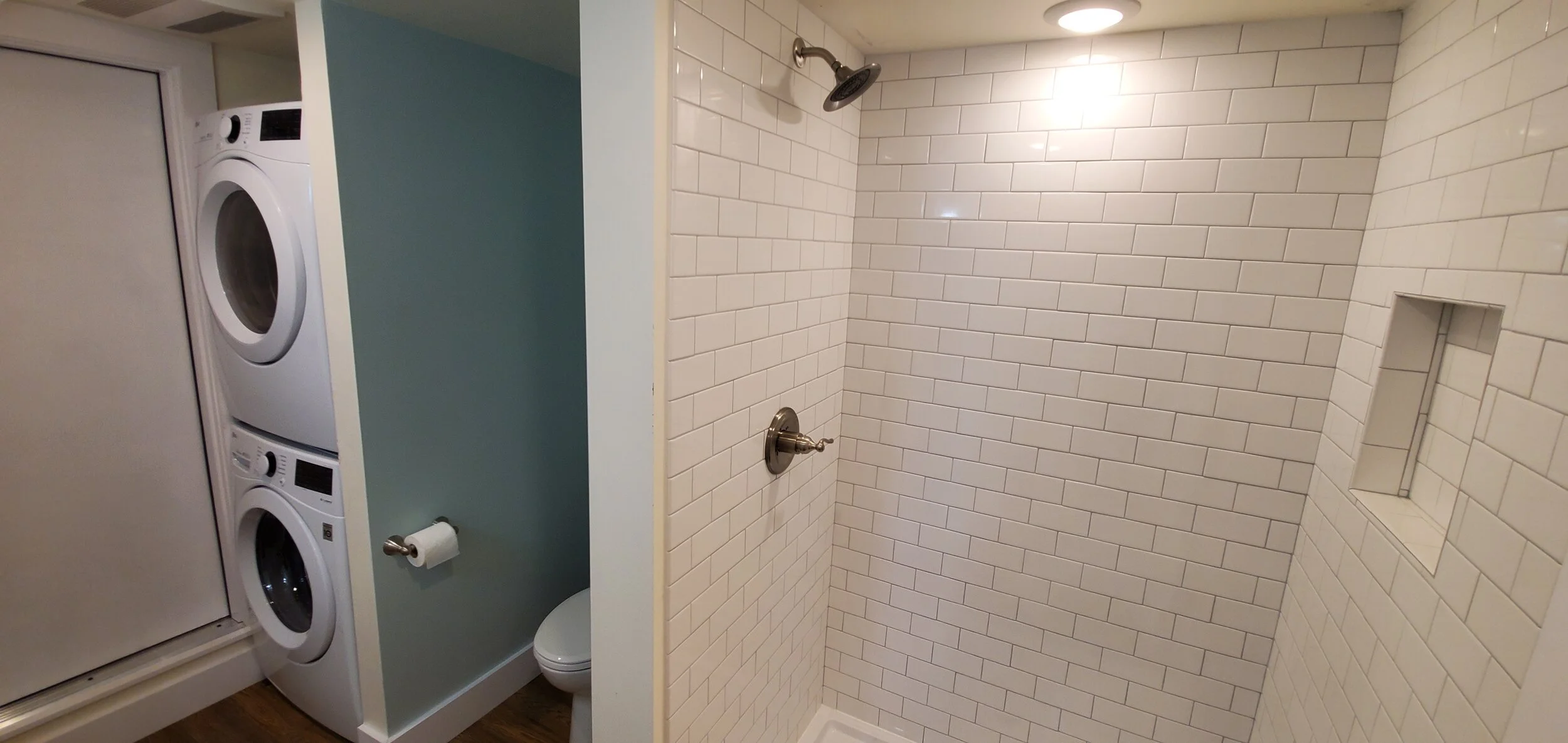 A laundry area with stacked washers and dryers next to a small toilet and a separate shower stall with white subway tiles.