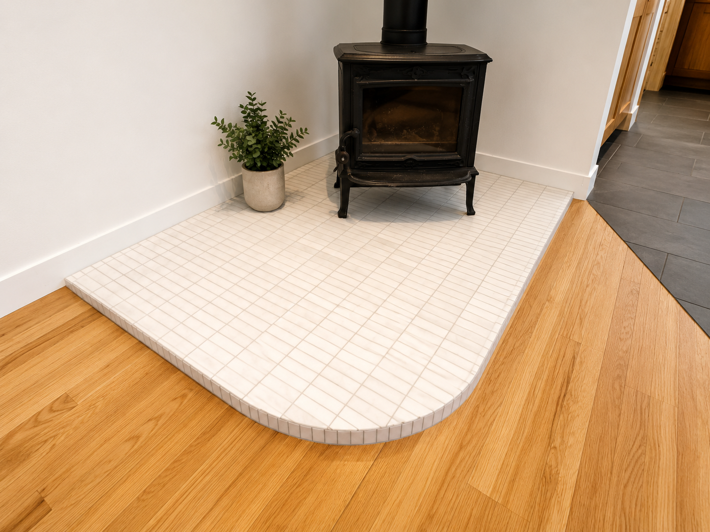 Custom curved tile transition detail in Southeast Portland home renovation.
