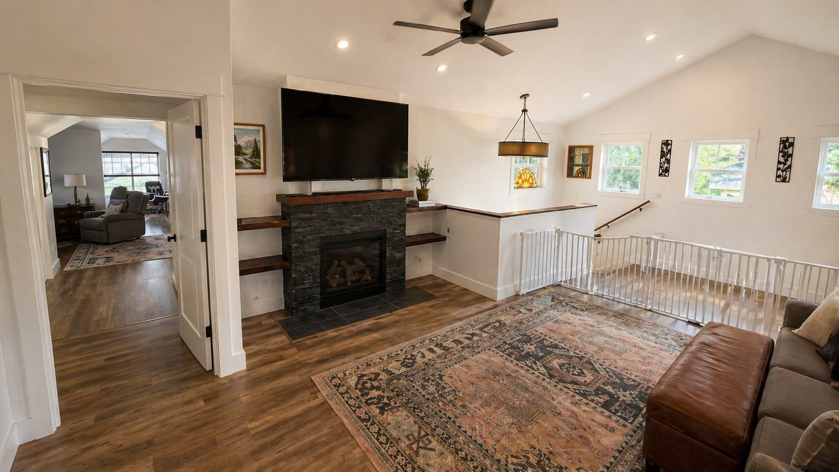 Custom second story living room addition with fireplace and built in shelving in Portland home remodel